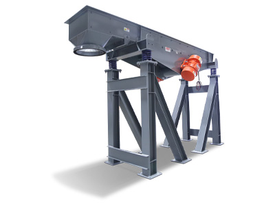 Feeder-Vibratory | Carrier Vibrating Industrial vibrating feeder mounted on a heavy-duty steel frame with motor and orange drive unit